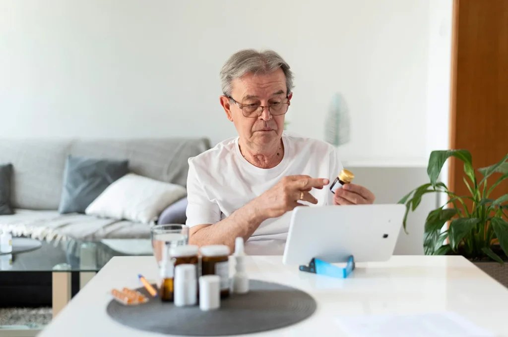 medium shot old man talking online doctor