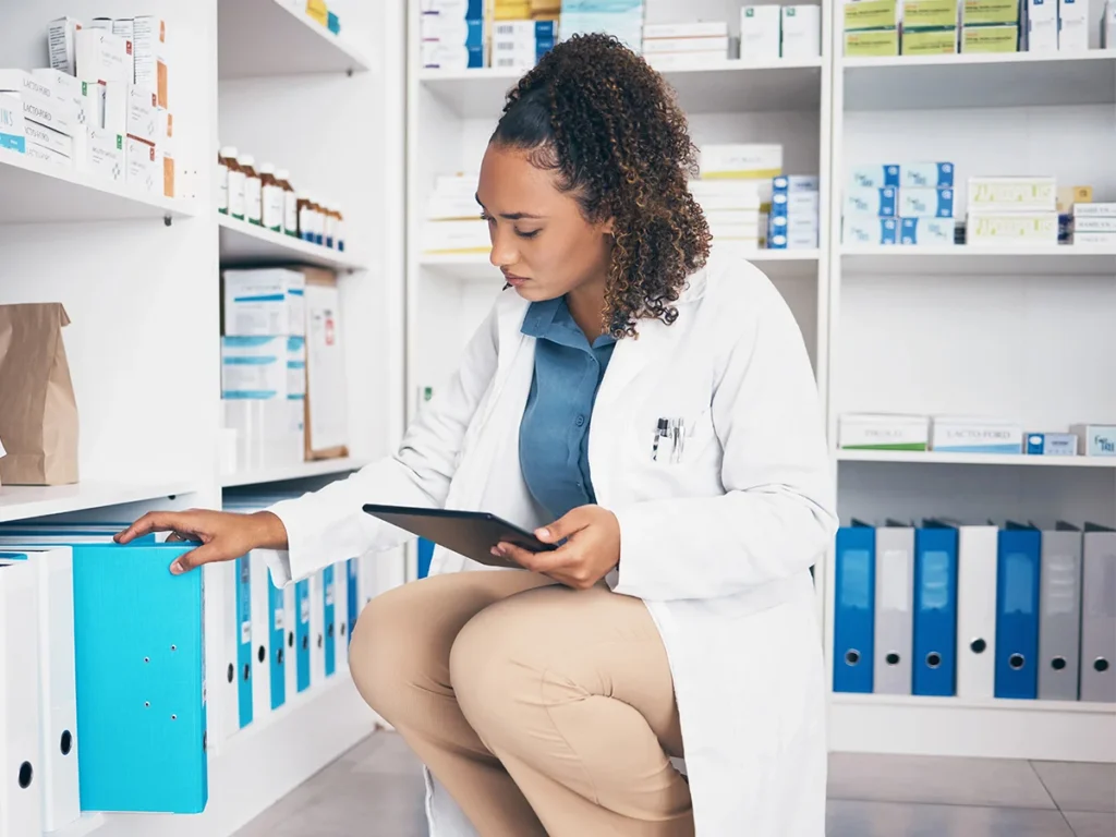 pharmacy shelf file and pharmacist woman on table