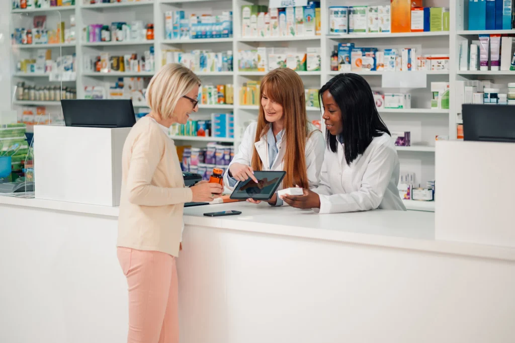 senior woman consulting with pharmacists in pharma