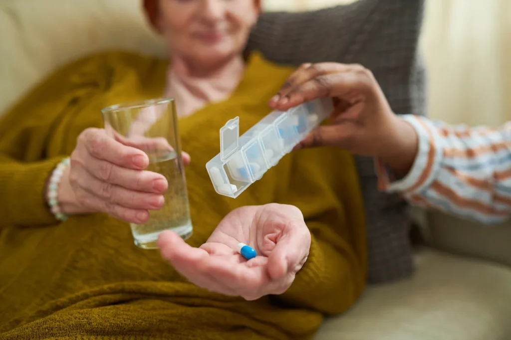 senior woman taking medication at her home