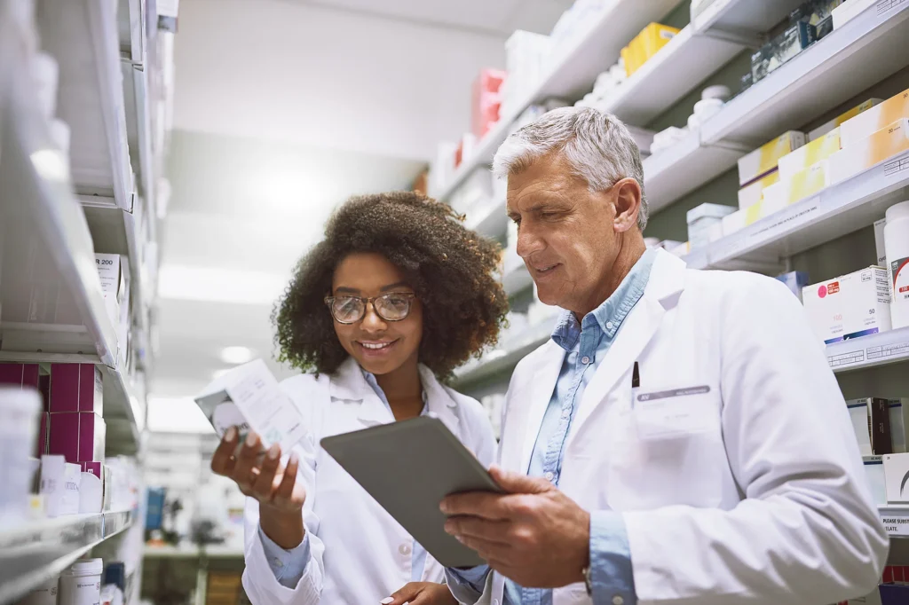 two professionals reviewing medicine inventory